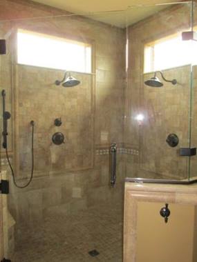 tile shower surround with tile flooring and shower fixtures